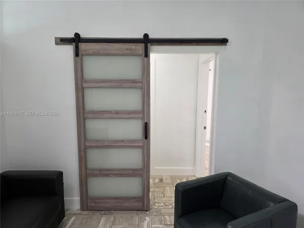 a living room with a couch and a walk in closet