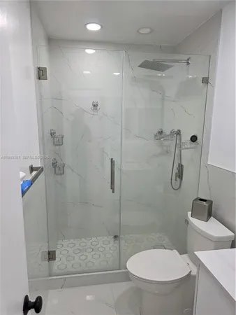 a bathroom with a toilet and a shower