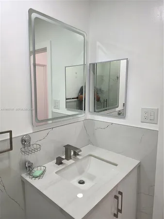 a bathroom with a sink and a mirror