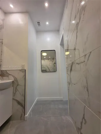 a view of a hallway with paintings on the wall