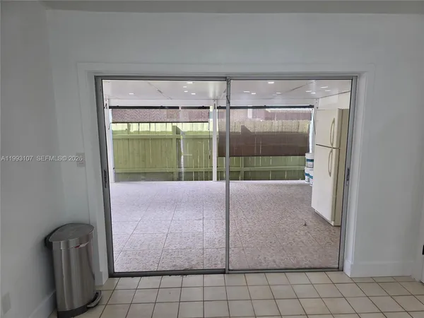 a view of a glass door with a bench