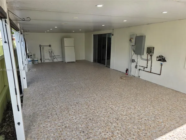 a view of a livingroom with furniture and a refrigerator