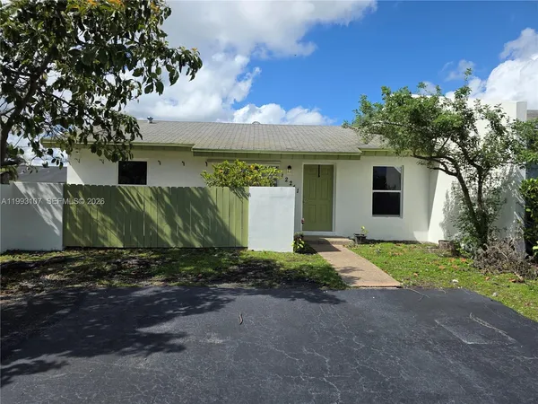 a view of a house with a yard and garage