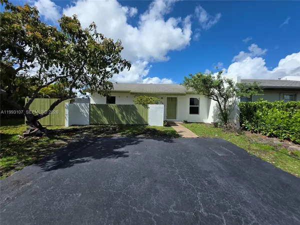 a view of a house with a yard and tree s