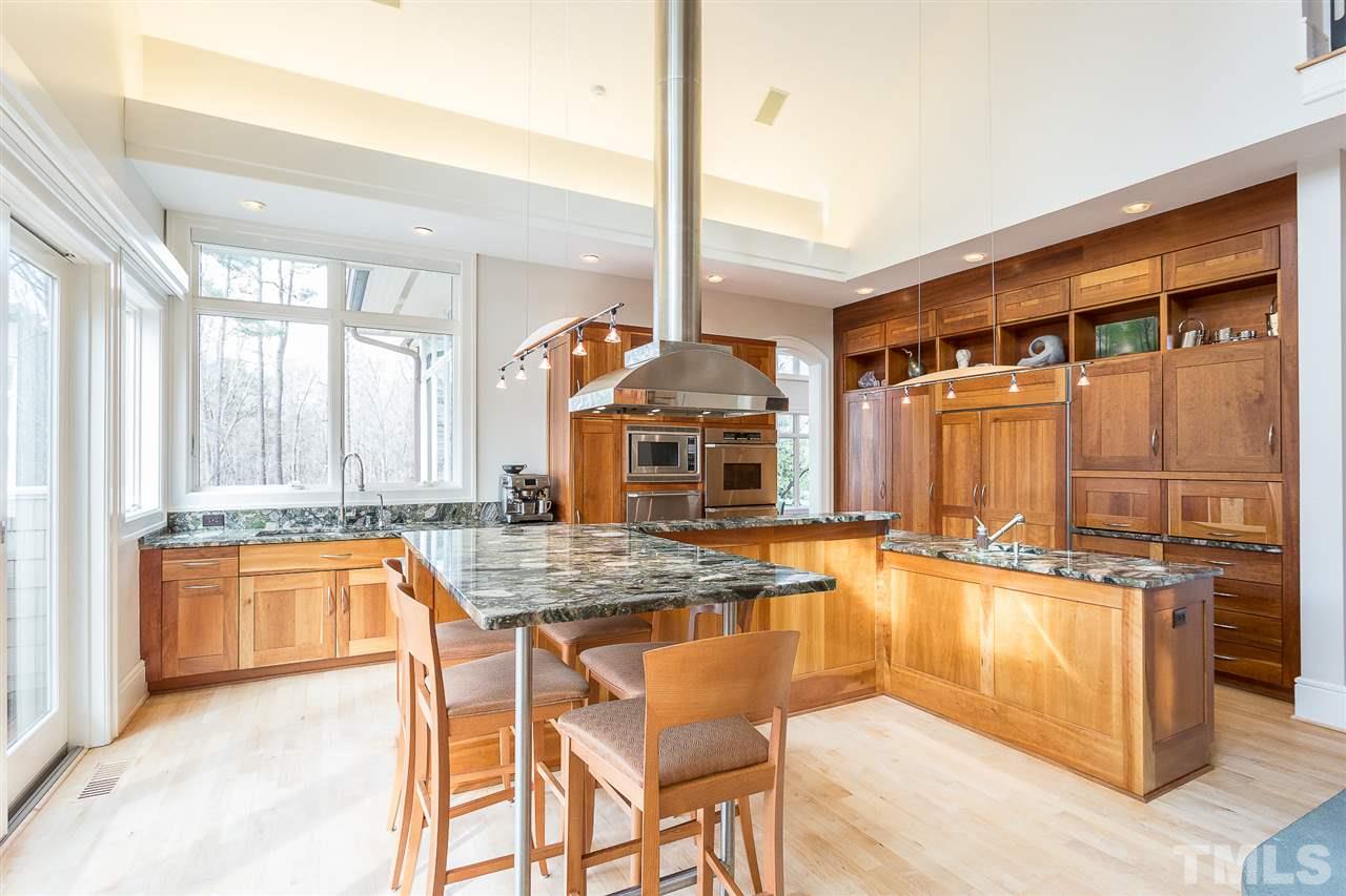 1117 Baslow Brook Court Raleigh, NC 27614 - Photo 11 of 30 a kitchen with stainless steel appliances granite countertop a stove a sink and a microwave