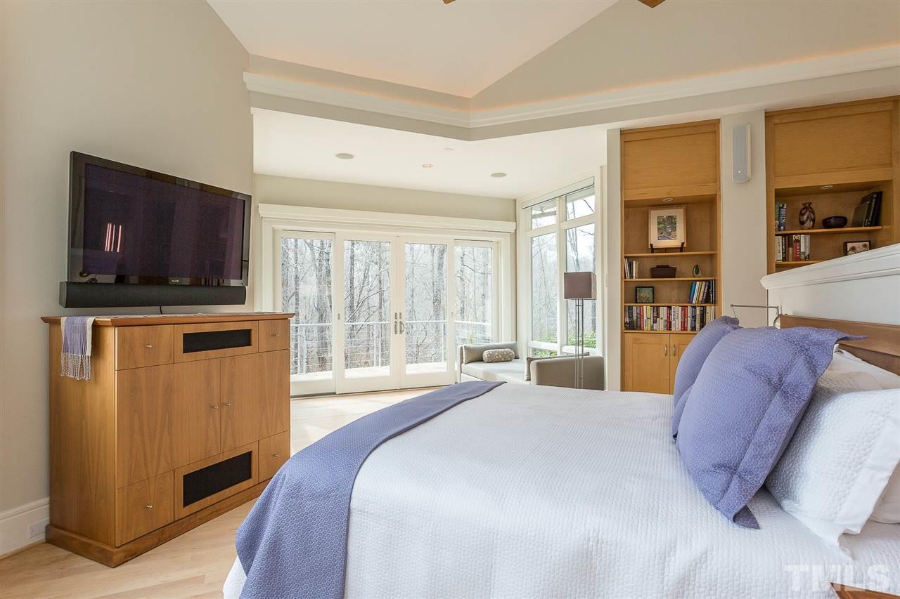 1117 Baslow Brook Court Raleigh, NC 27614 - Photo 16 of 30 a spacious bedroom with a bed and a flat screen television