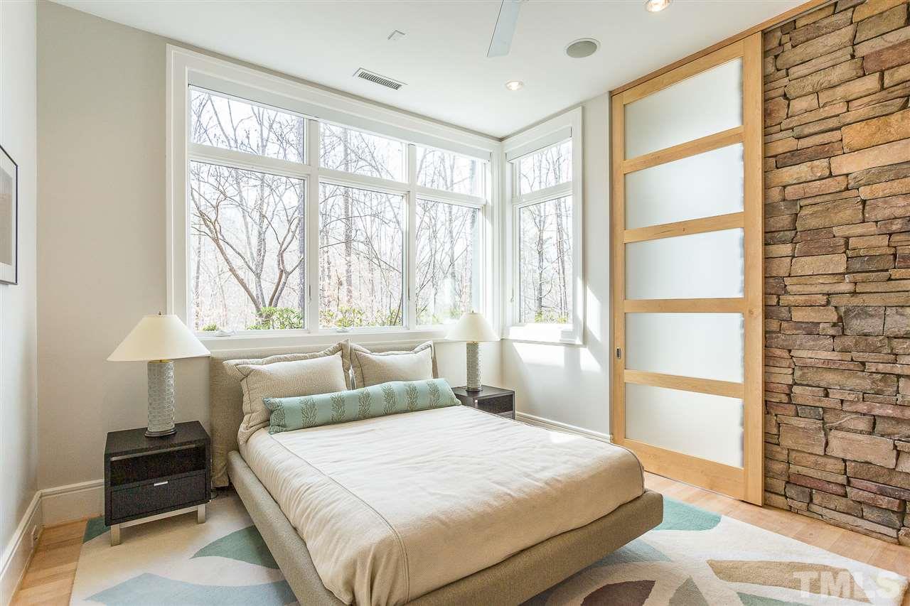 1117 Baslow Brook Court Raleigh, NC 27614 - Photo 28 of 30 a bedroom with a bed and a lamp on the dresser