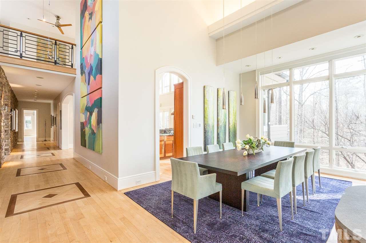 1117 Baslow Brook Court Raleigh, NC 27614 - Photo 10 of 30 a view of a dining room with furniture large windows and wooden floor
