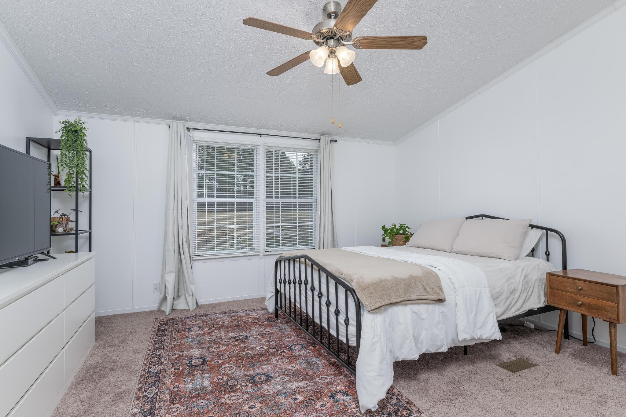 720 Armstrong Road Southeast Cleveland, TN 37323 - Photo 8 of 16 a bedroom with a bed chandelier and a window