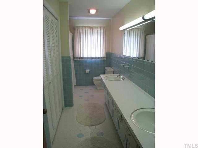 2706 Sparger Road Durham, NC 27705 - Photo 8 of 12 Tile floor & walls. Linen closet & 2 vanities