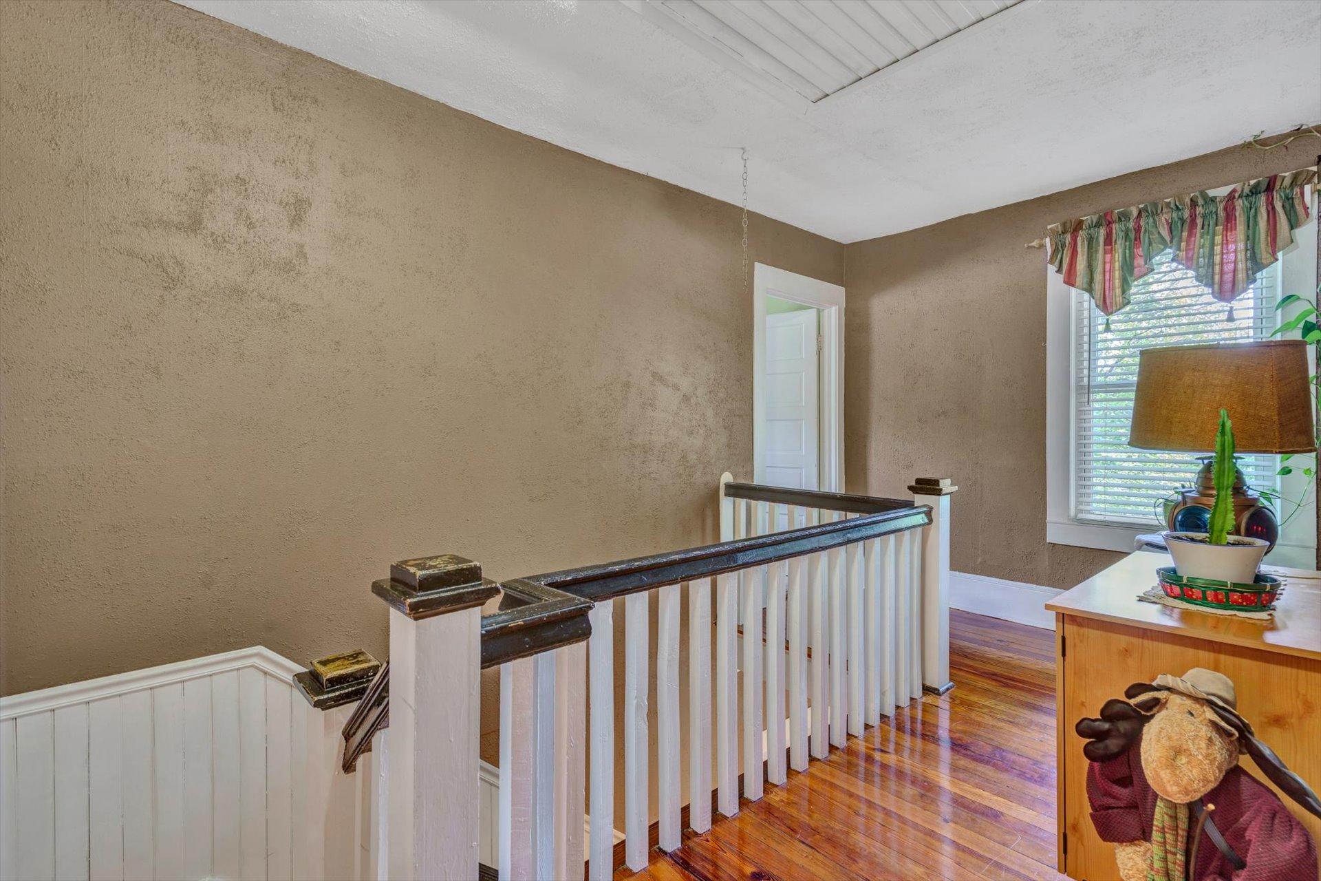 6044 Cove Road Roanoke, VA 24019 - Photo 18 of 67 a view of a hallway to a livingroom with wooden floor and furniture