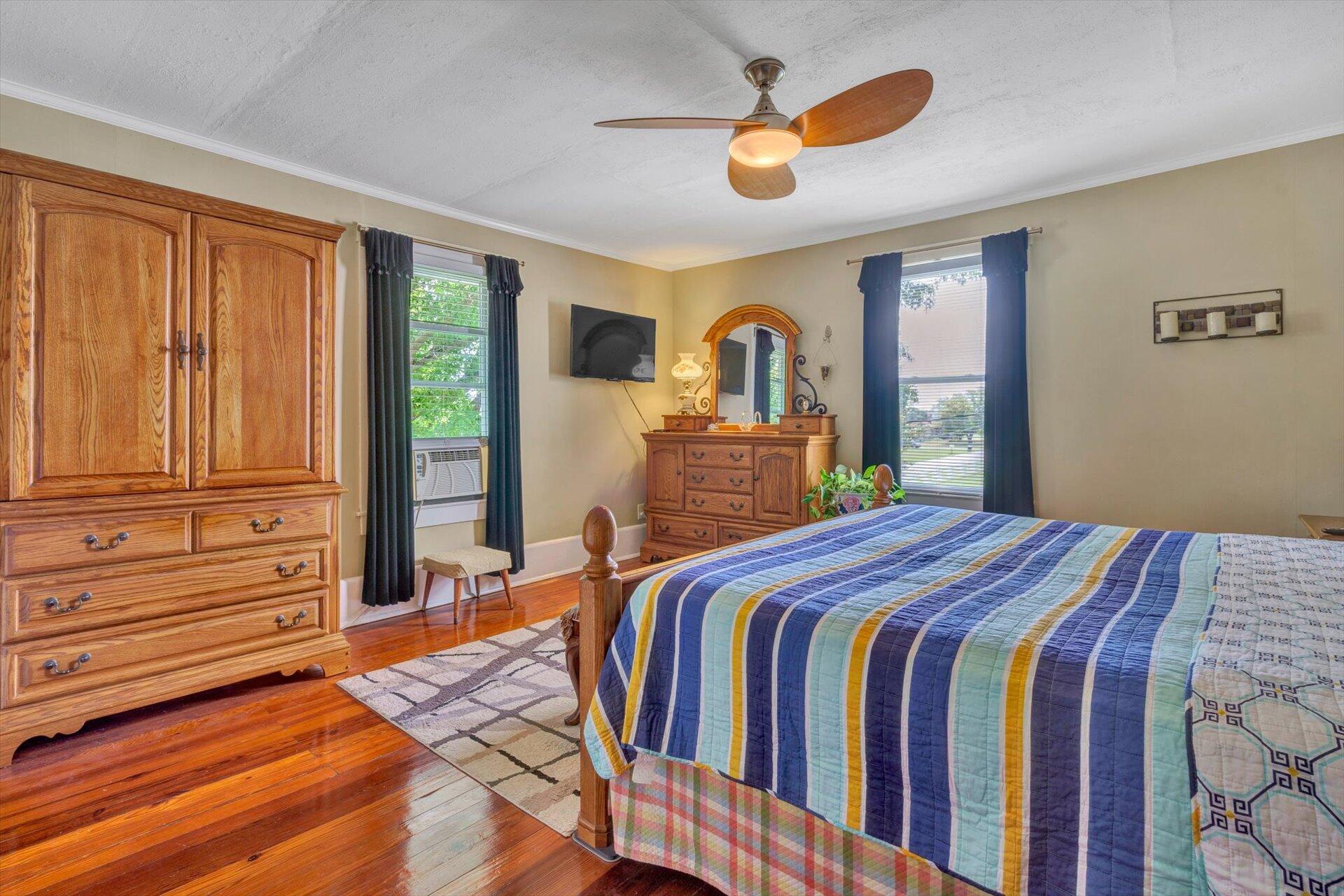 6044 Cove Road Roanoke, VA 24019 - Photo 19 of 67 a bedroom with a bed and a chandelier