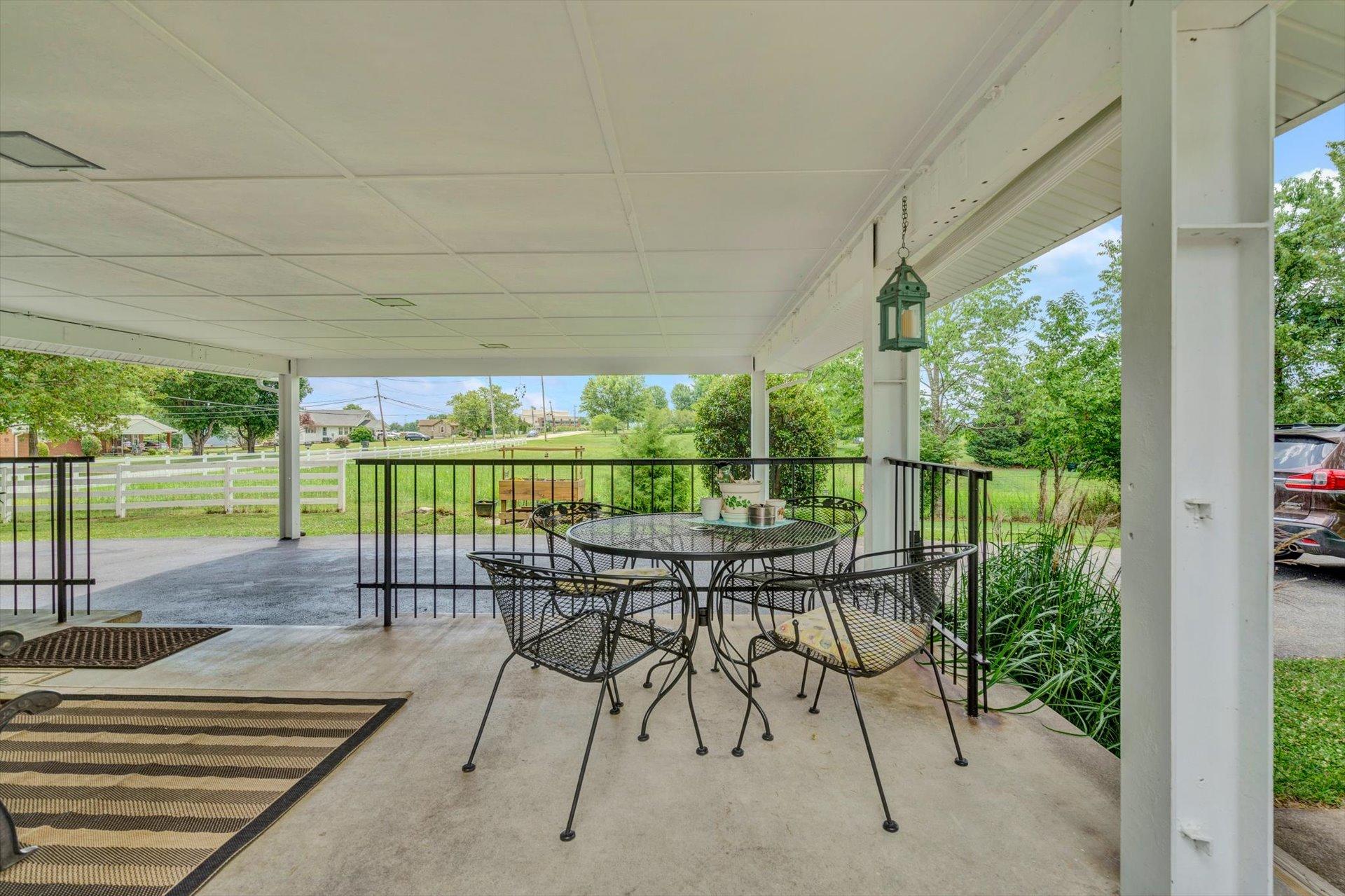 6044 Cove Road Roanoke, VA 24019 - Photo 28 of 67 a patio with yard glass top table and chairs
