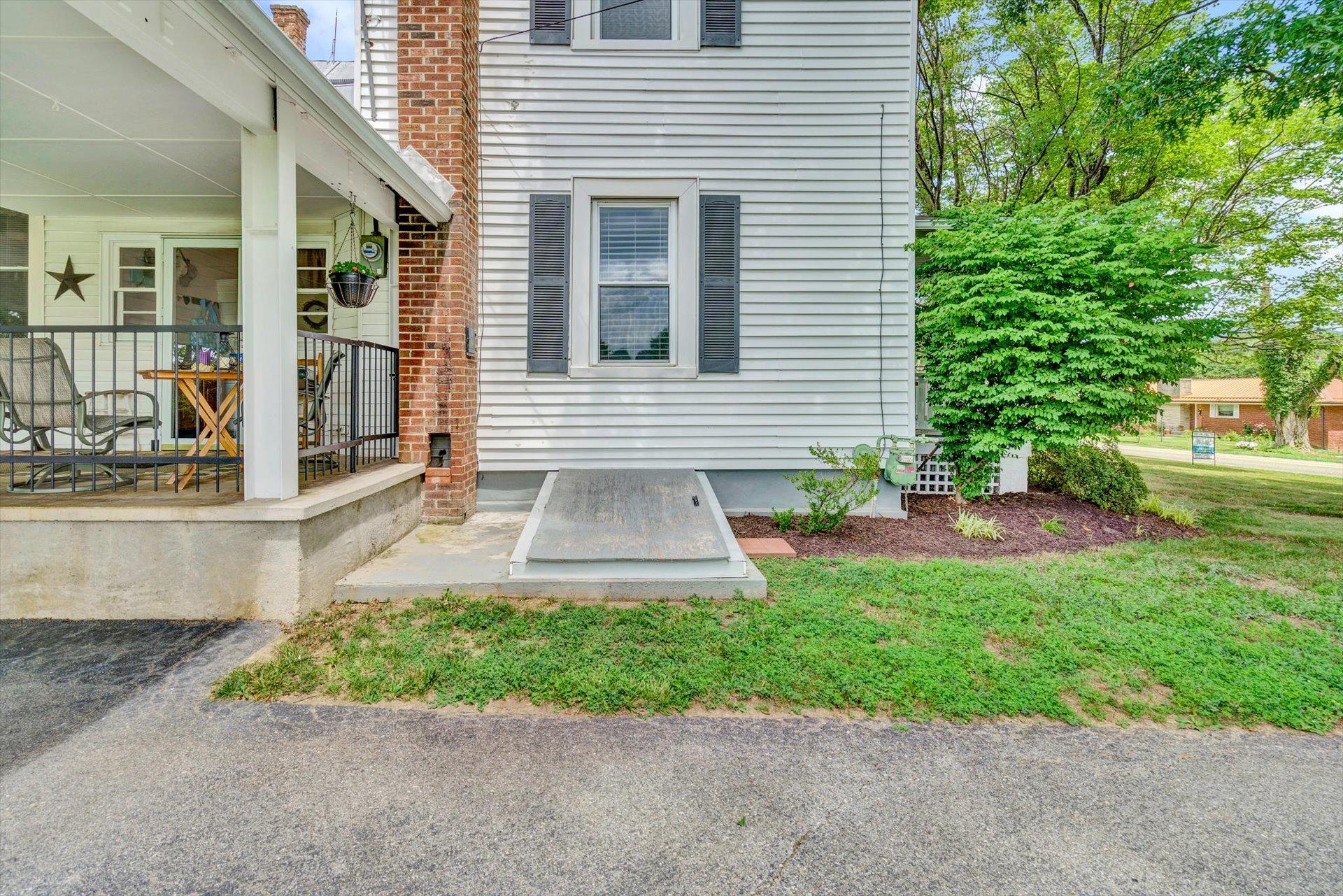 6044 Cove Road Roanoke, VA 24019 - Photo 53 of 67 a front view of a house with a yard and outdoor seating