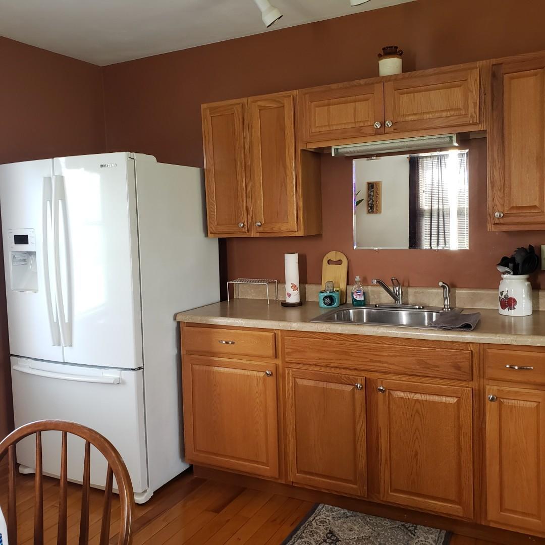 6044 Cove Road Roanoke, VA 24019 - Photo 63 of 67 a kitchen with cabinets a refrigerator and a sink