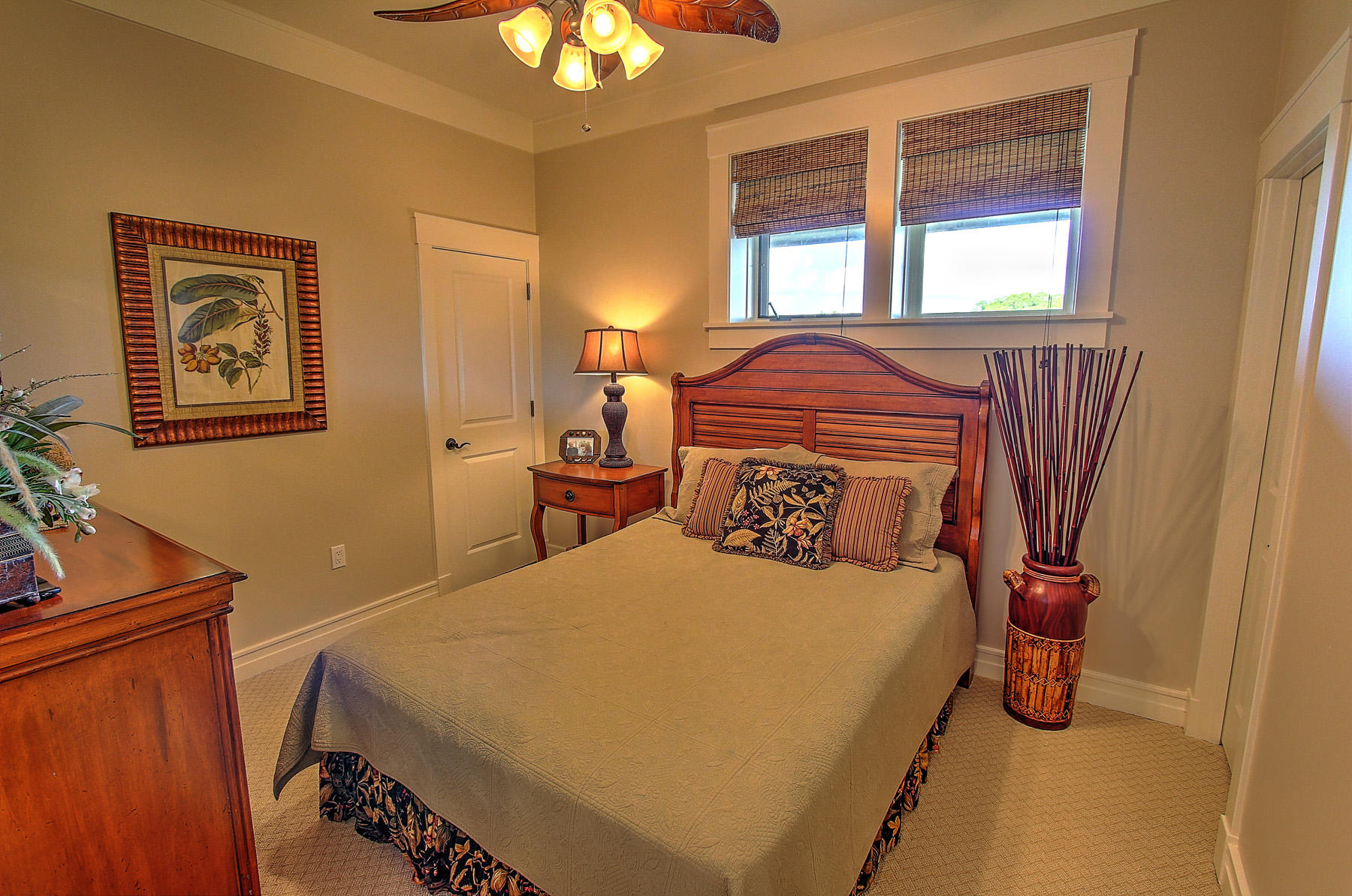 1101 Prospect Promenade, Unit 401 Panama City Beach, FL 32413 - Photo 14 of 35 a bedroom with a bed and wooden floor