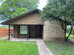 a view of a wooden door in front of a house