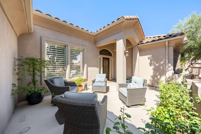1609 East 10 S Street St. George, UT 84790 - Photo 6 of 68 Inviting outdoor patio space with stucco exterior, arched portico entrance, tile roof, and integrated landscaping