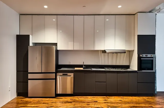 a kitchen with a refrigerator and a stove