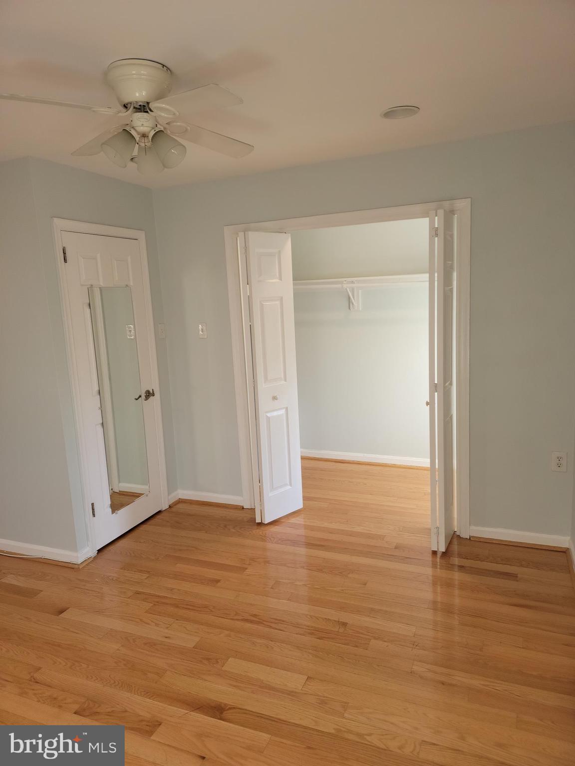 133 North Payne Street, Unit 2 Alexandria, VA 22314 - Photo 12 of 16 a view of an empty room with wooden floor and a ceiling fan