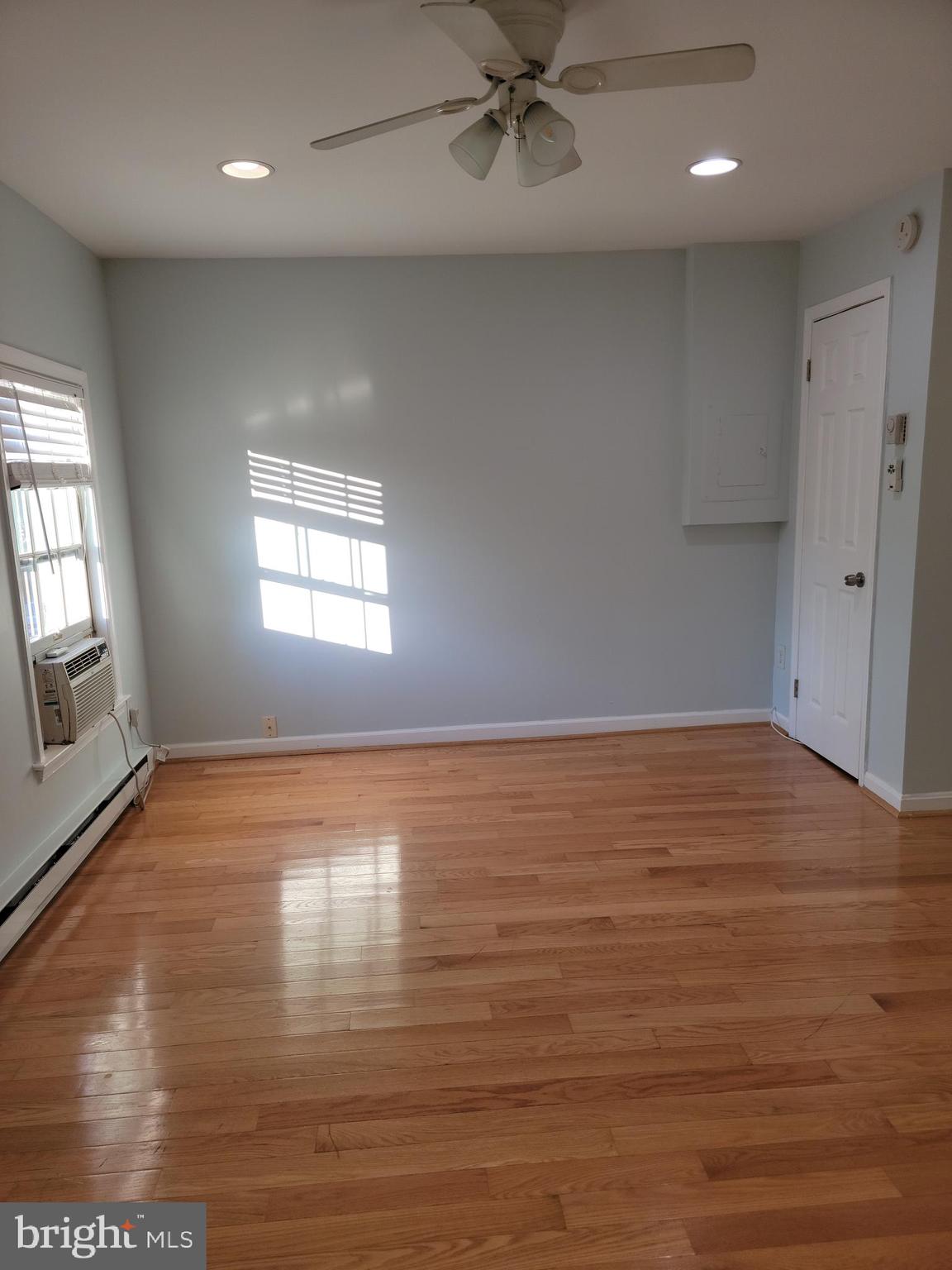 133 North Payne Street, Unit 2 Alexandria, VA 22314 - Photo 14 of 16 an empty room with wooden floor and windows