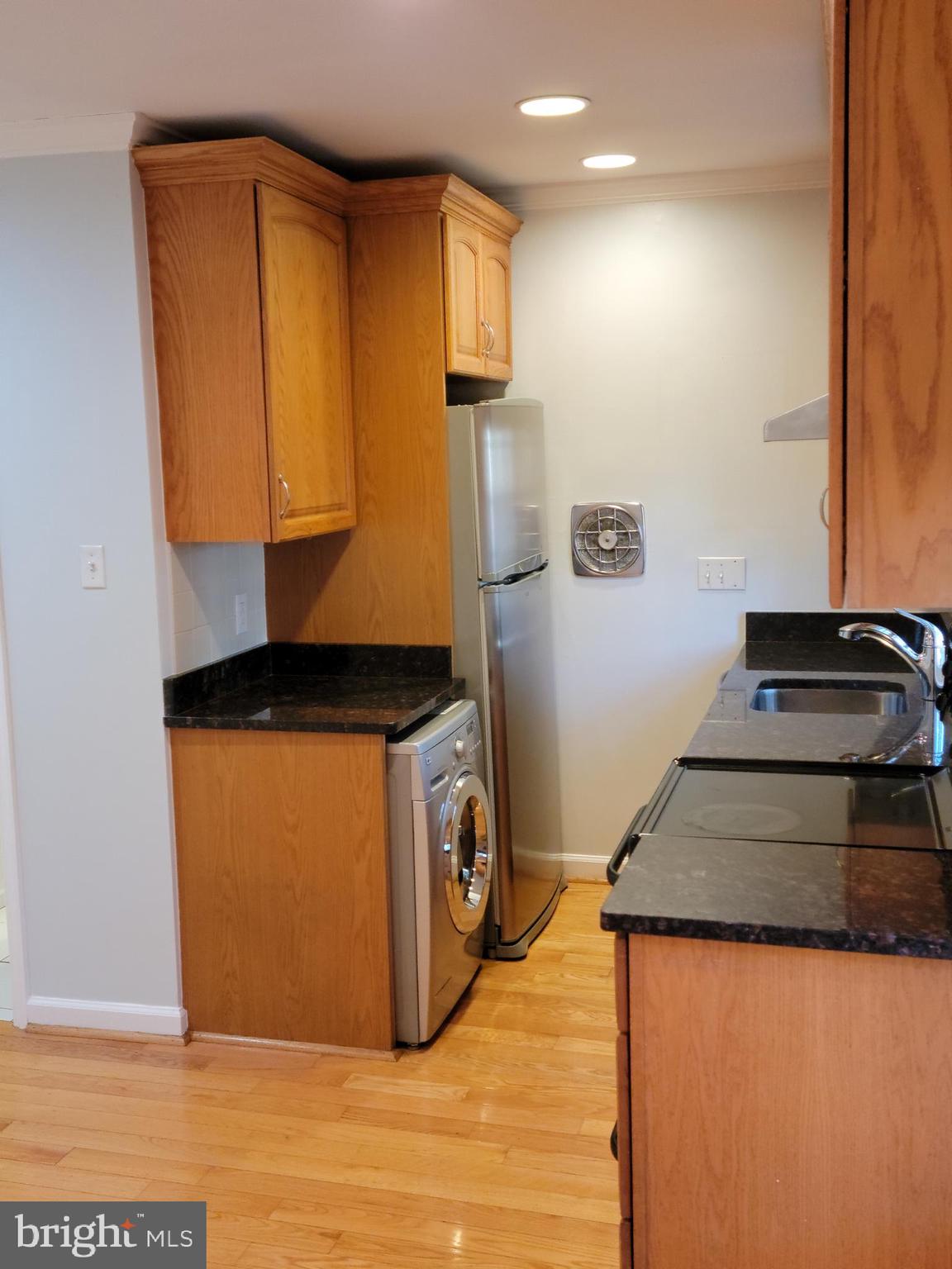 133 North Payne Street, Unit 2 Alexandria, VA 22314 - Photo 2 of 16 a kitchen with a refrigerator and a stove