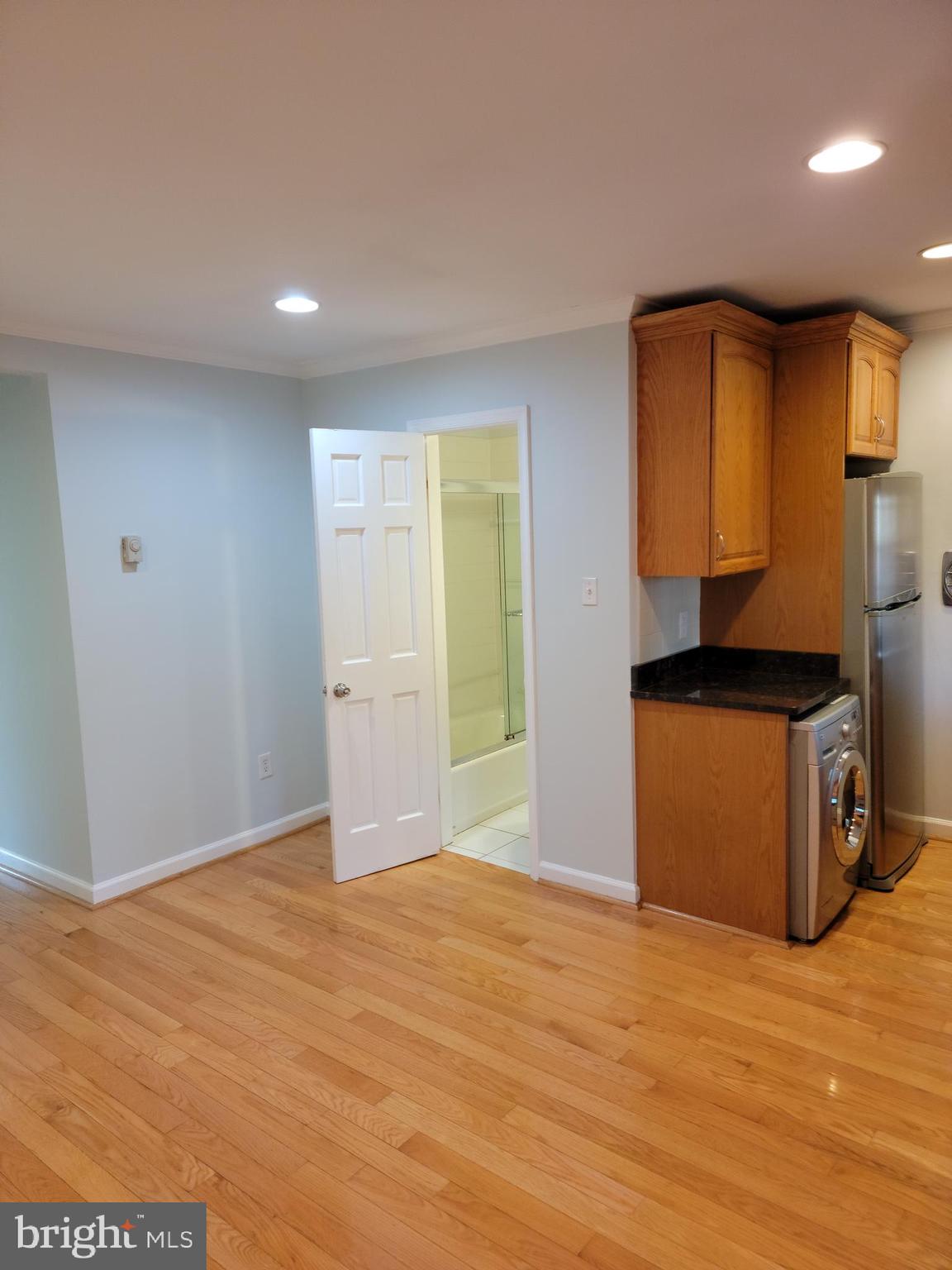 133 North Payne Street, Unit 2 Alexandria, VA 22314 - Photo 3 of 16 a bedroom with a bed and a dresser in it