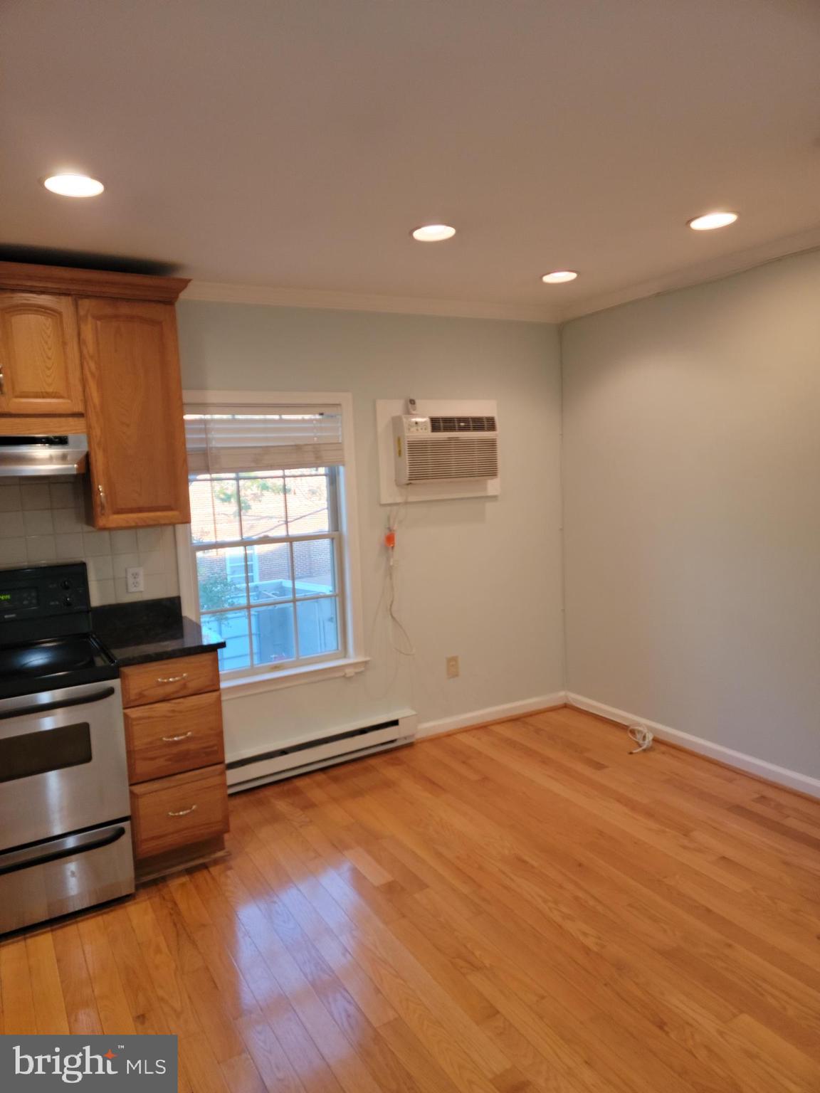 133 North Payne Street, Unit 2 Alexandria, VA 22314 - Photo 6 of 16 a kitchen with stainless steel appliances granite countertop a stove a sink and a refrigerator