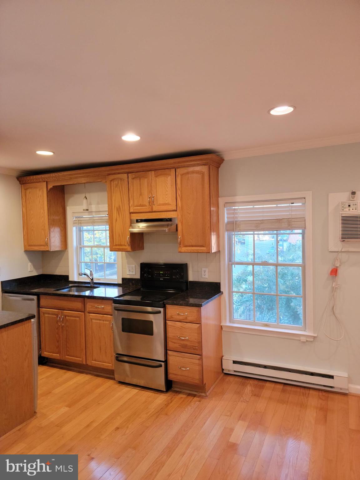 133 North Payne Street, Unit 2 Alexandria, VA 22314 - Photo 7 of 16 a kitchen with stainless steel appliances granite countertop a stove a sink and a microwave