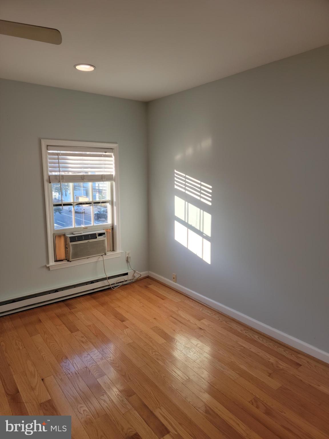 133 North Payne Street, Unit 2 Alexandria, VA 22314 - Photo 10 of 16 an empty room with wooden floor and windows