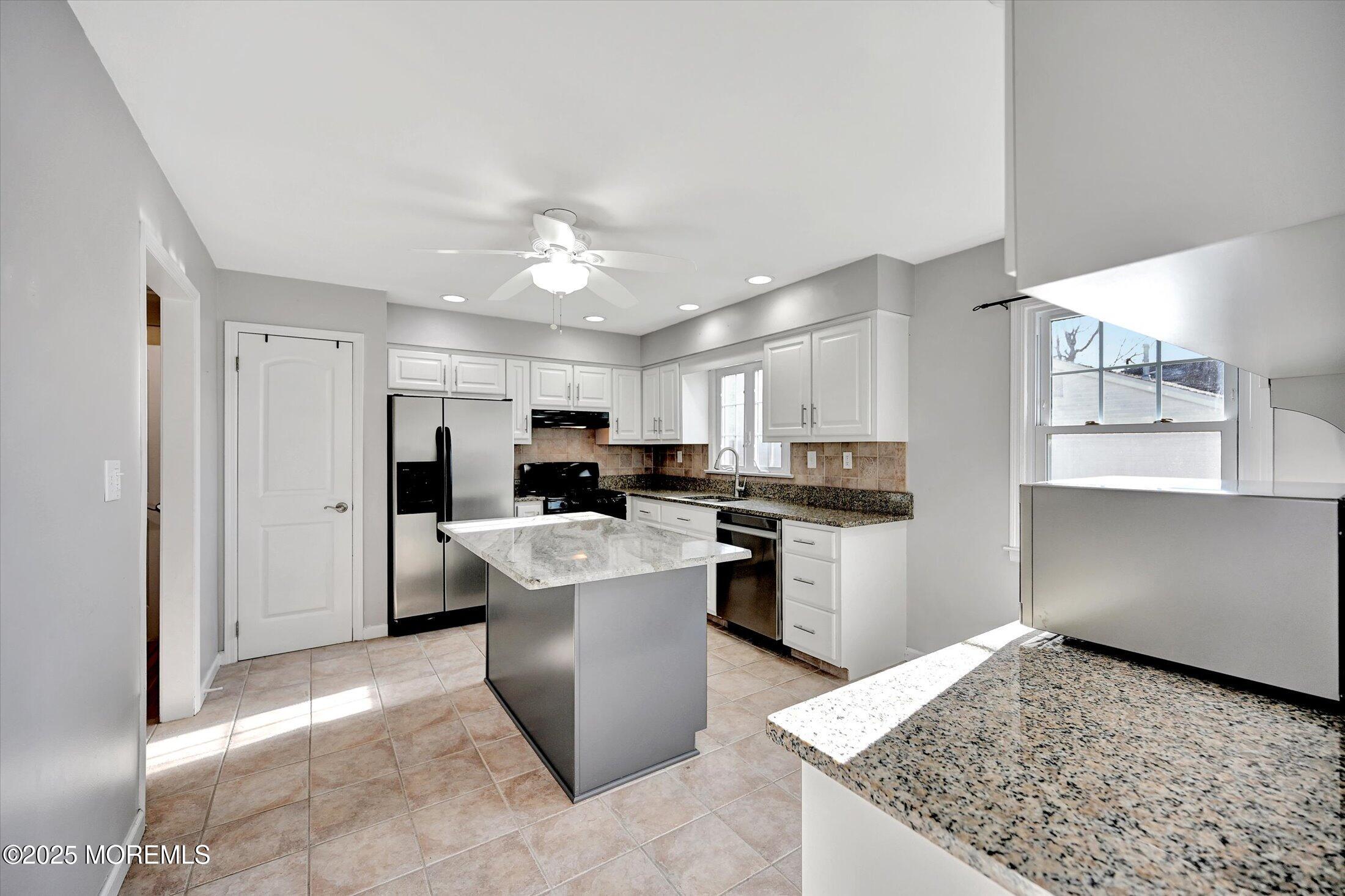 539 Summit Drive Point Pleasant, NJ 08742 - Photo 12 of 33 a kitchen with stainless steel appliances granite countertop a sink stove and refrigerator