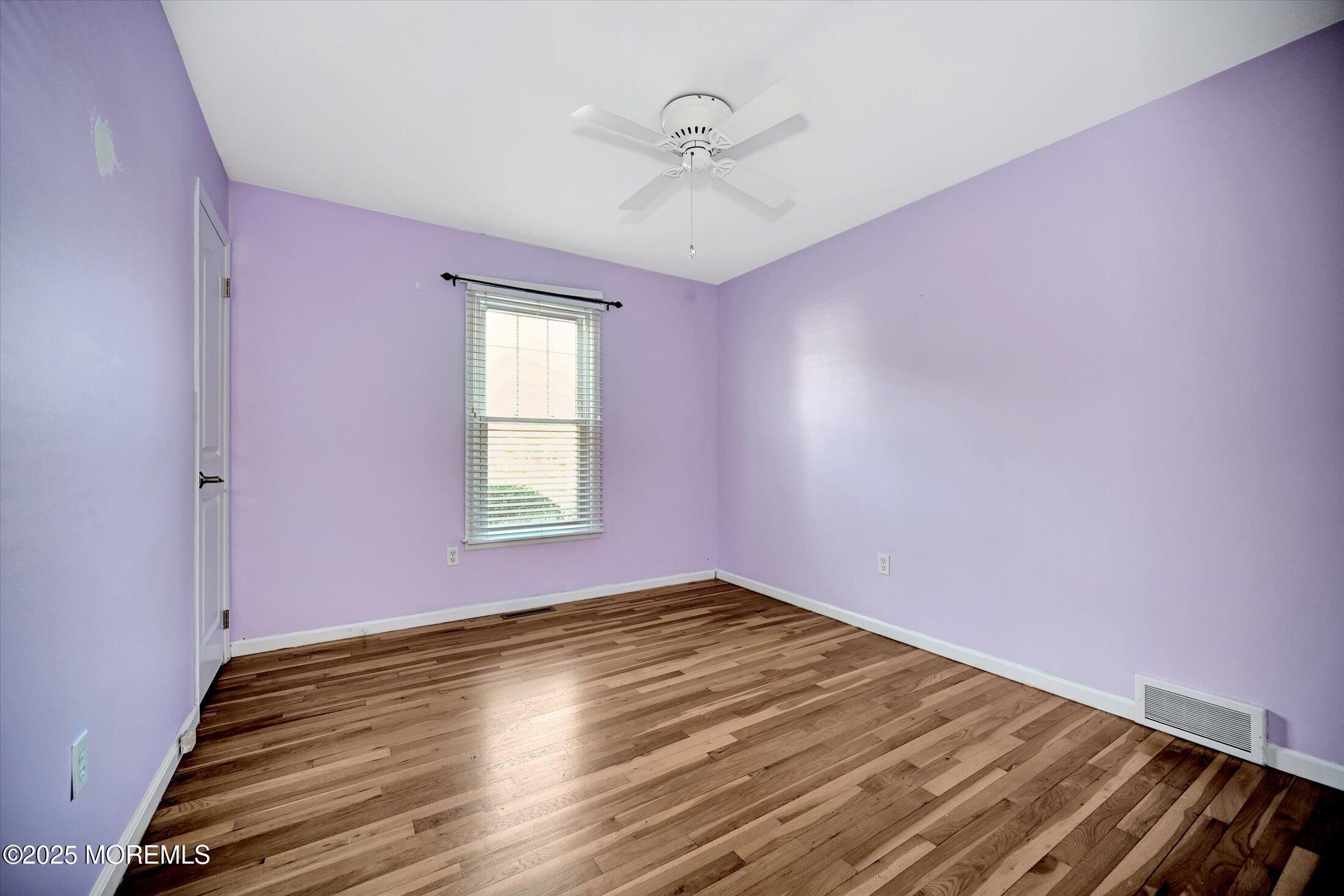 539 Summit Drive Point Pleasant, NJ 08742 - Photo 22 of 33 a view of empty room with wooden floor and fan