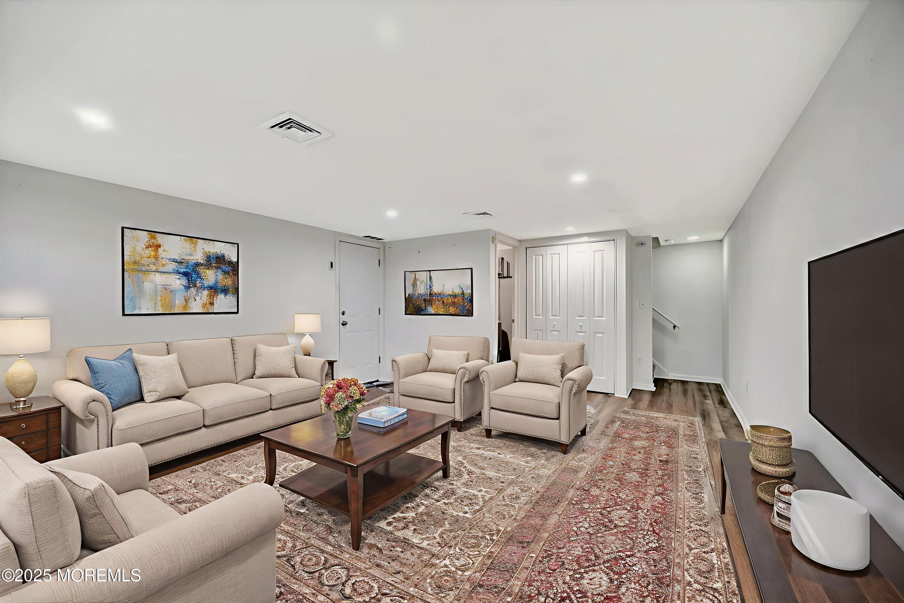 539 Summit Drive Point Pleasant, NJ 08742 - Photo 24 of 33 a living room with furniture a rug and a flat screen tv