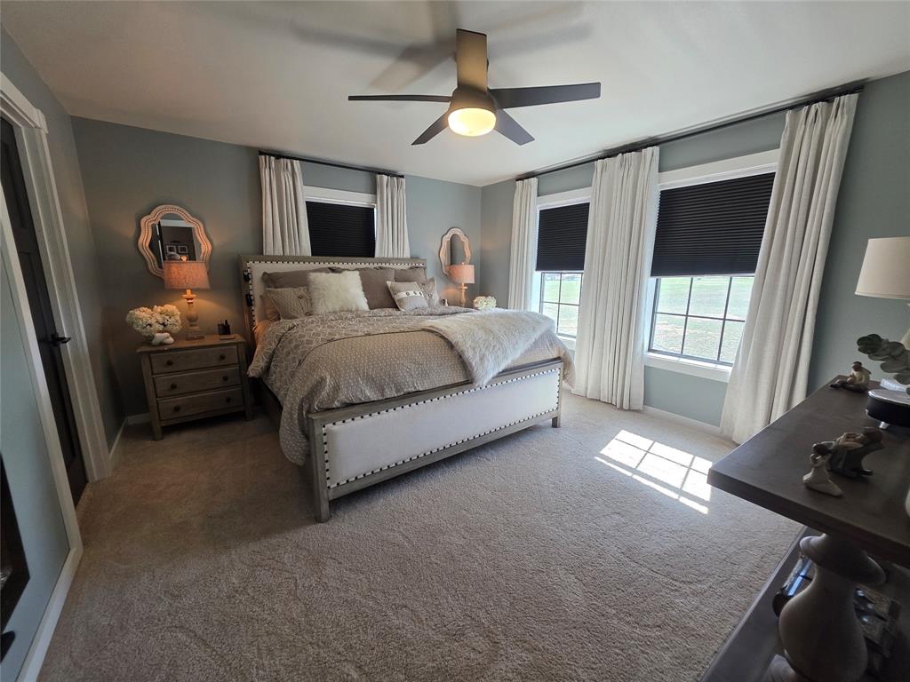 1225 R R G Loop Olney, TX 76374 - Photo 12 of 40 a spacious bedroom with a large bed and a window