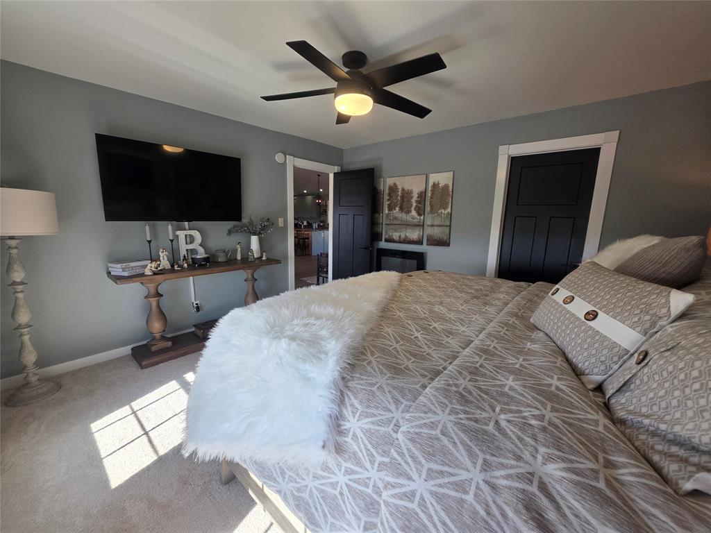 1225 R R G Loop Olney, TX 76374 - Photo 13 of 40 a bedroom with a bed a window and a flat screen tv