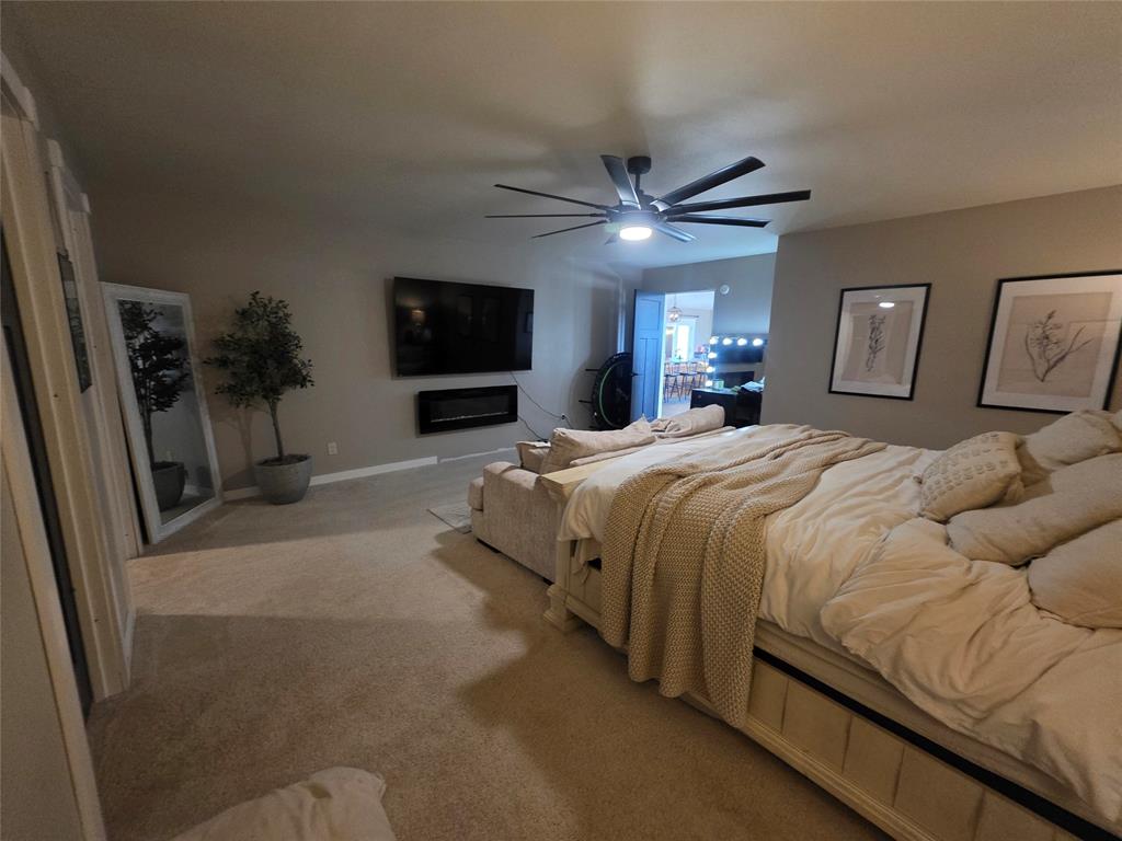 1225 R R G Loop Olney, TX 76374 - Photo 18 of 40 a spacious bedroom with a bed and a flat screen tv