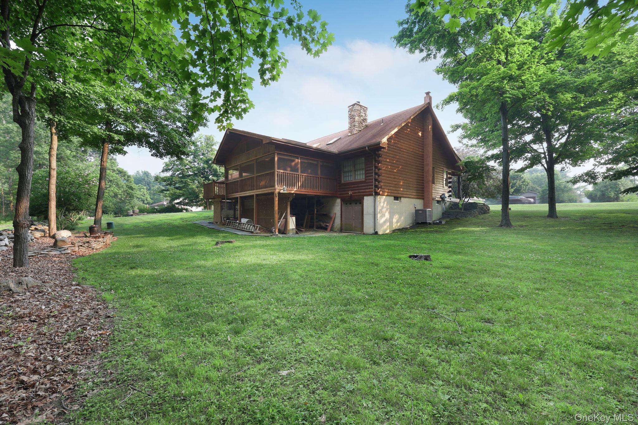 230 Post Road Slate Hill, NY 10973 - Photo 25 of 26 Back of the home shown here with the enclosed screened porch and basement entry door.