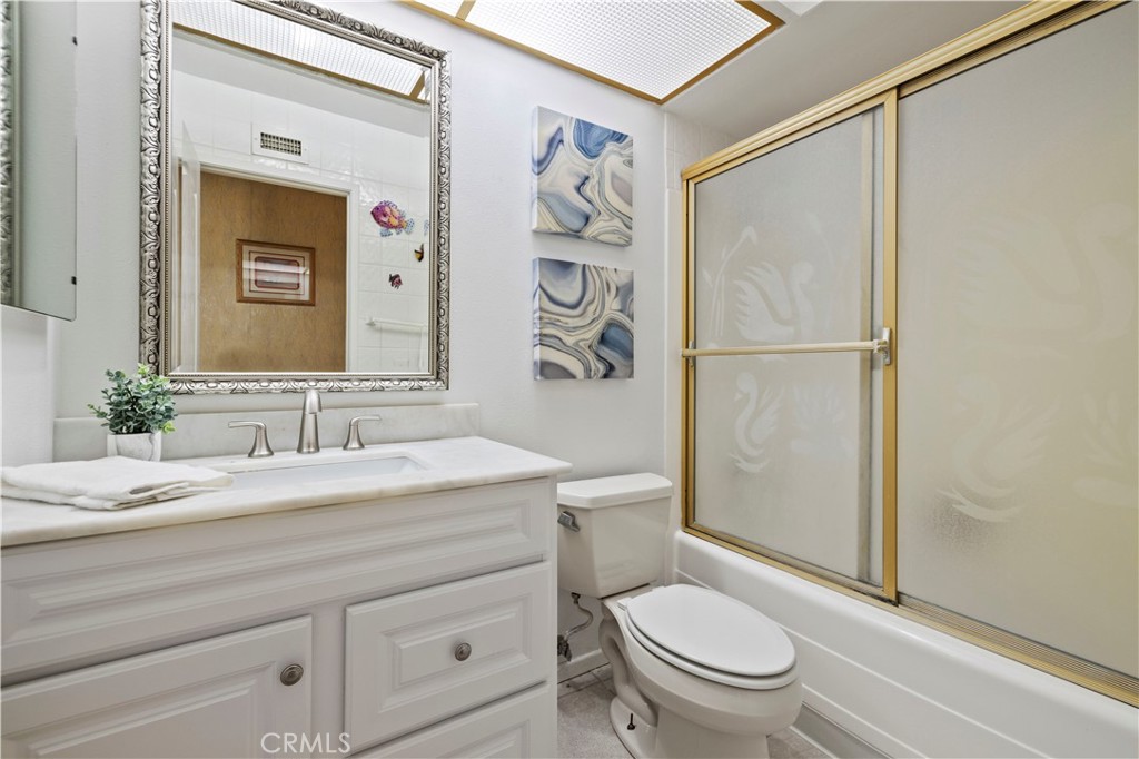 28784 Eagleton Street Agoura Hills, CA 91301 - Photo 29 of 48 a bathroom with a granite countertop sink toilet a mirror and shower