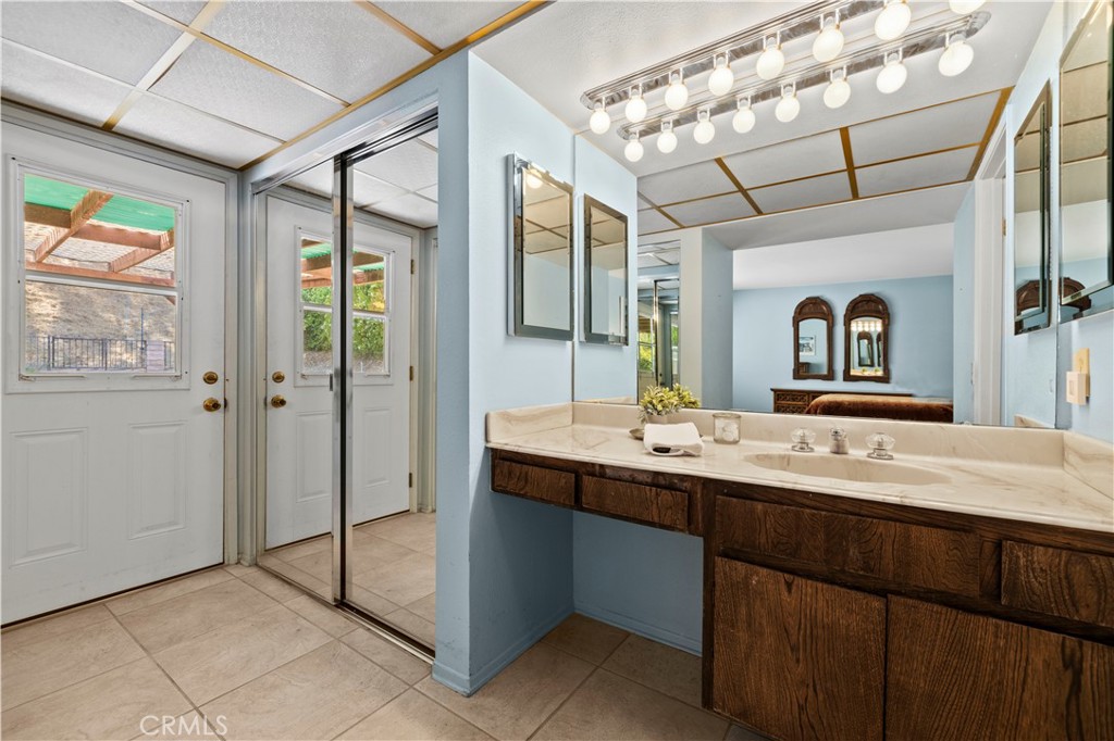 28784 Eagleton Street Agoura Hills, CA 91301 - Photo 33 of 48 a bathroom with a sink a mirror and a shower