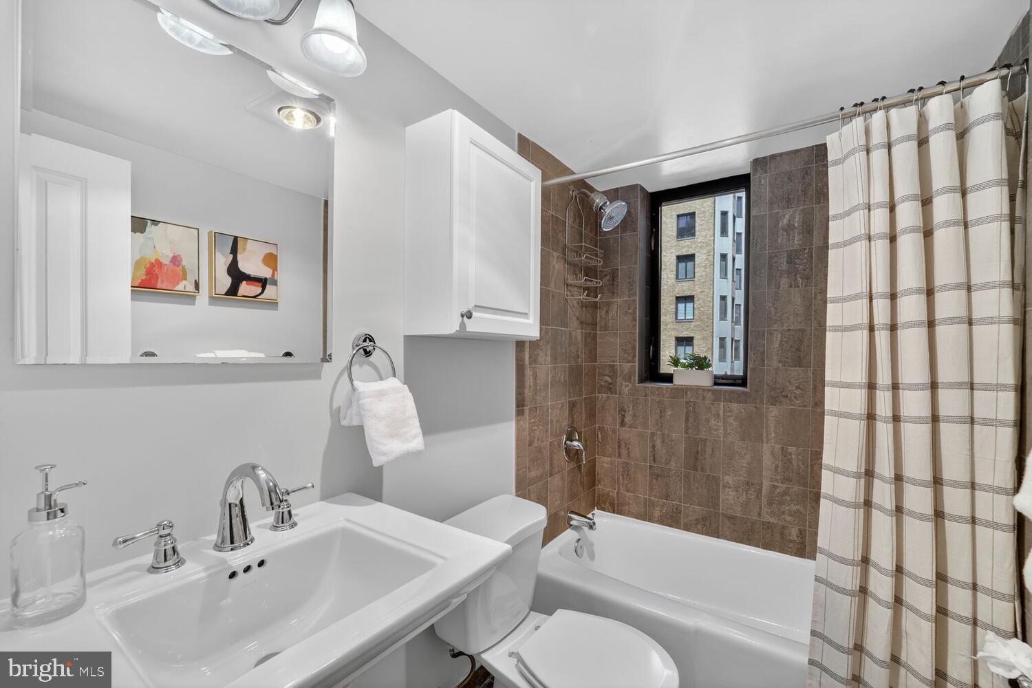1701 16th Street Northwest, Unit 440 Washington, DC 20009 - Photo 16 of 31 a bathroom with a sink toilet and shower