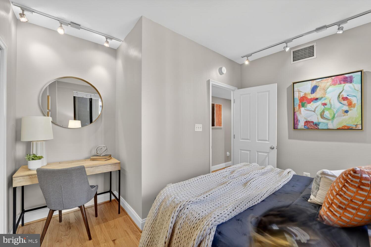 1701 16th Street Northwest, Unit 440 Washington, DC 20009 - Photo 19 of 31 a bedroom with a bed and a table in it