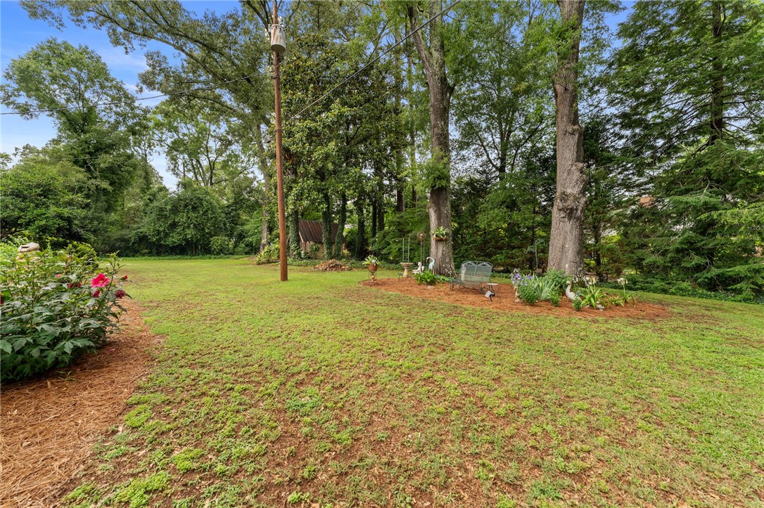 1105 Greenacres Anderson, SC 29621 - Photo 42 of 46 A spacious, verdant yard with mature trees providing ample shade and a natural retreat.