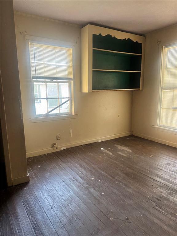 537 Rutherford Avenue Macon, GA 31206 - Photo 6 of 10 an empty room with wooden floor and windows