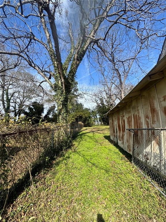 537 Rutherford Avenue Macon, GA 31206 - Photo 7 of 10 a view of backyard with wooden fence and large trees