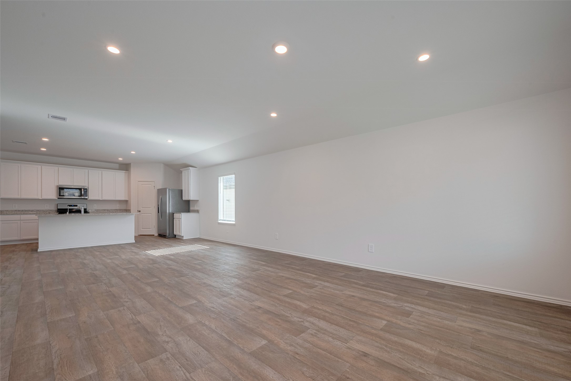 30842 Brightwell Bend Fulshear, TX 77441 - Photo 12 of 31 This expansive open-concept layout connects the kitchen, dining area, and living room—allowing effortless flow for both daily living and gathering with guests.