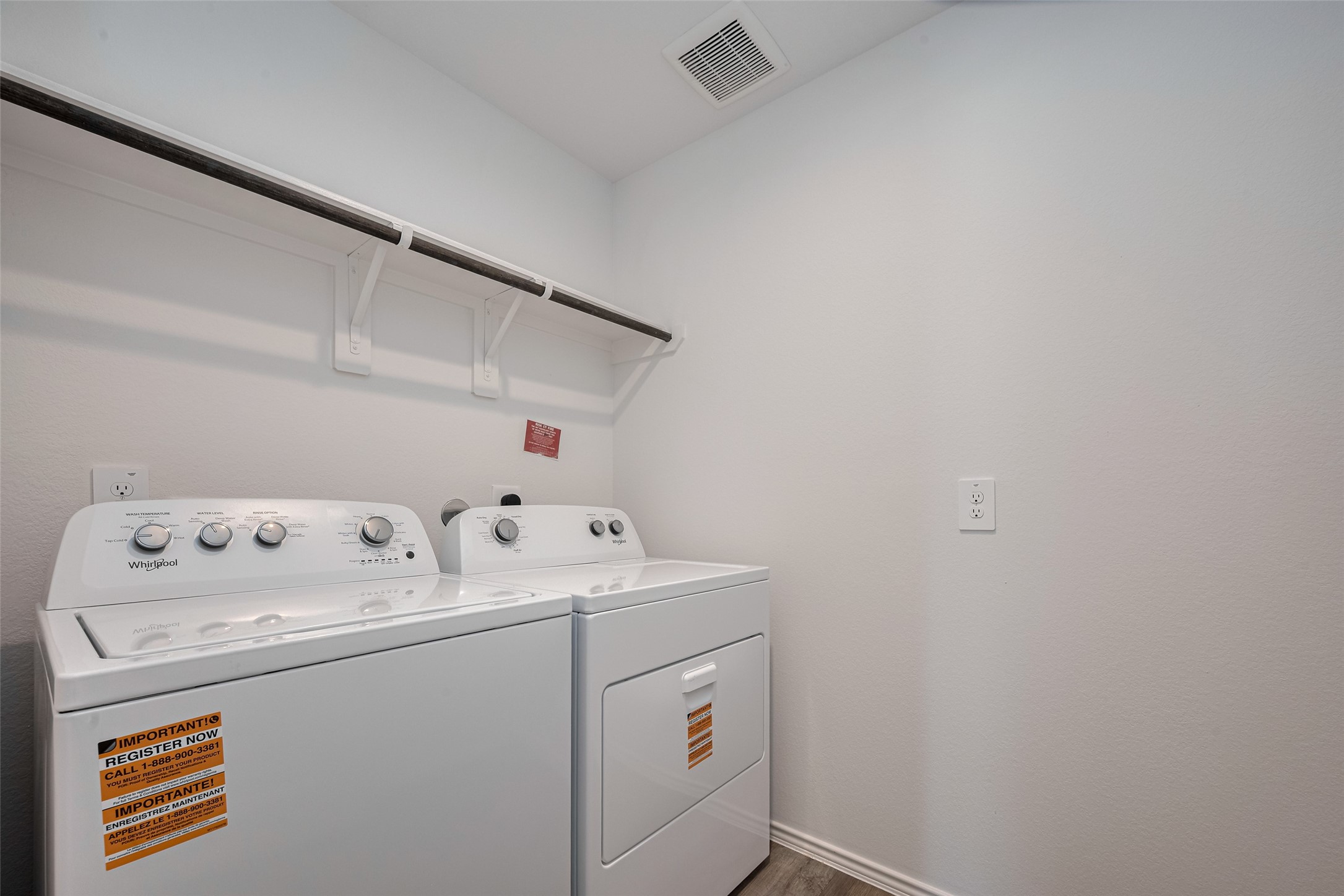 30842 Brightwell Bend Fulshear, TX 77441 - Photo 14 of 31 The laundry room features built-in shelving and a hanging rod over the washer and dryer—perfect for organizing and streamlining chores.