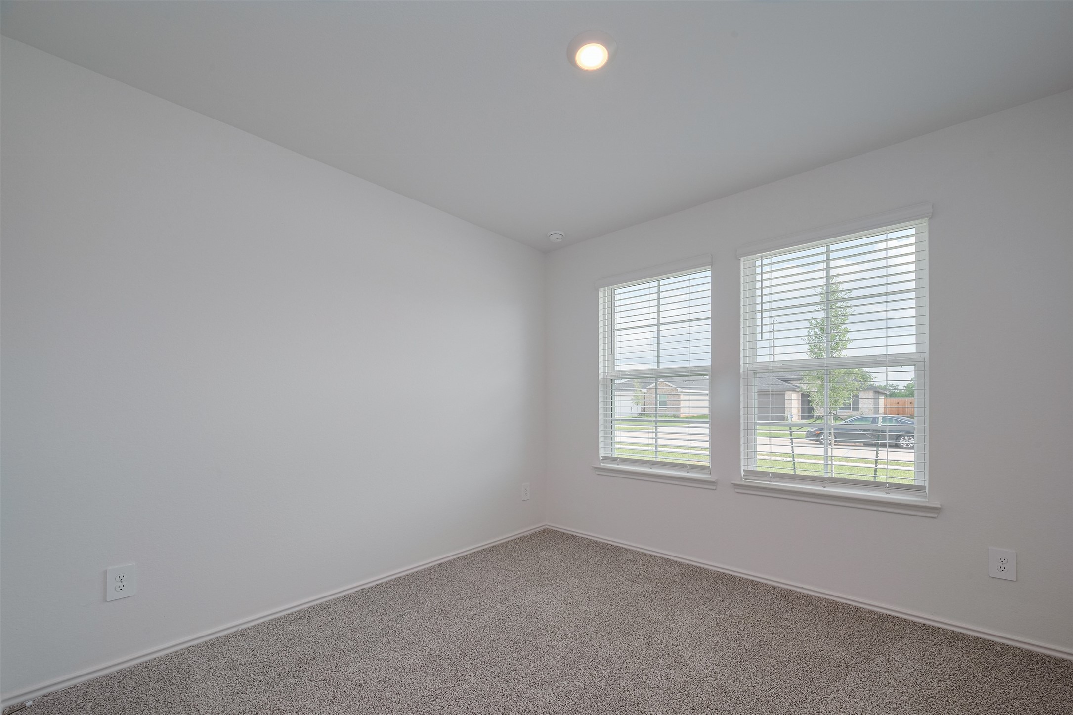 30842 Brightwell Bend Fulshear, TX 77441 - Photo 17 of 31 Another well-proportioned bedroom with plush carpet underfoot and windows that enhance the room’s airy and welcoming feel.