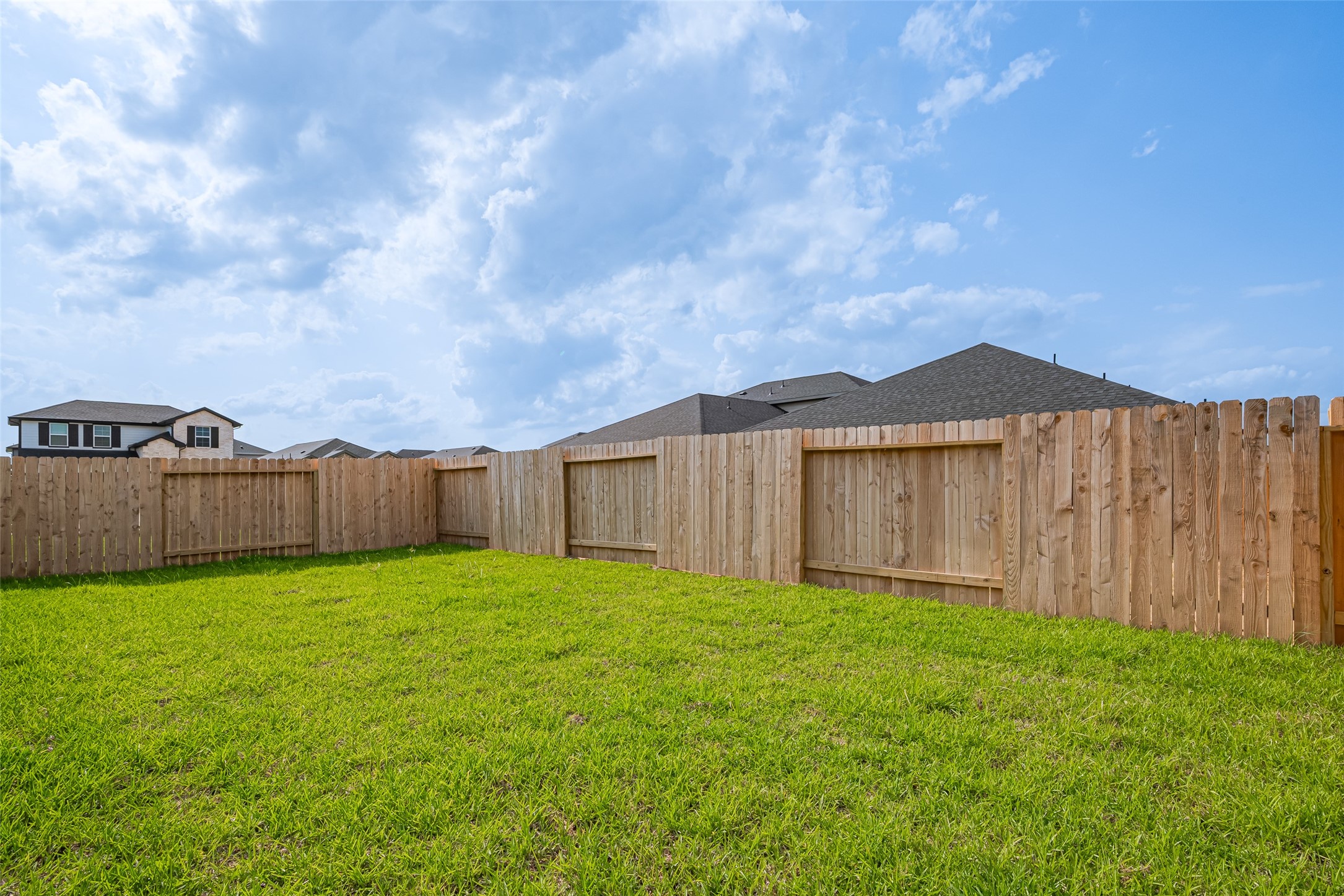 30842 Brightwell Bend Fulshear, TX 77441 - Photo 30 of 31 Spacious fenced backyard with lush green grass—perfect for pets, playtime, or future outdoor entertaining. A blank canvas ready for your dream garden or patio