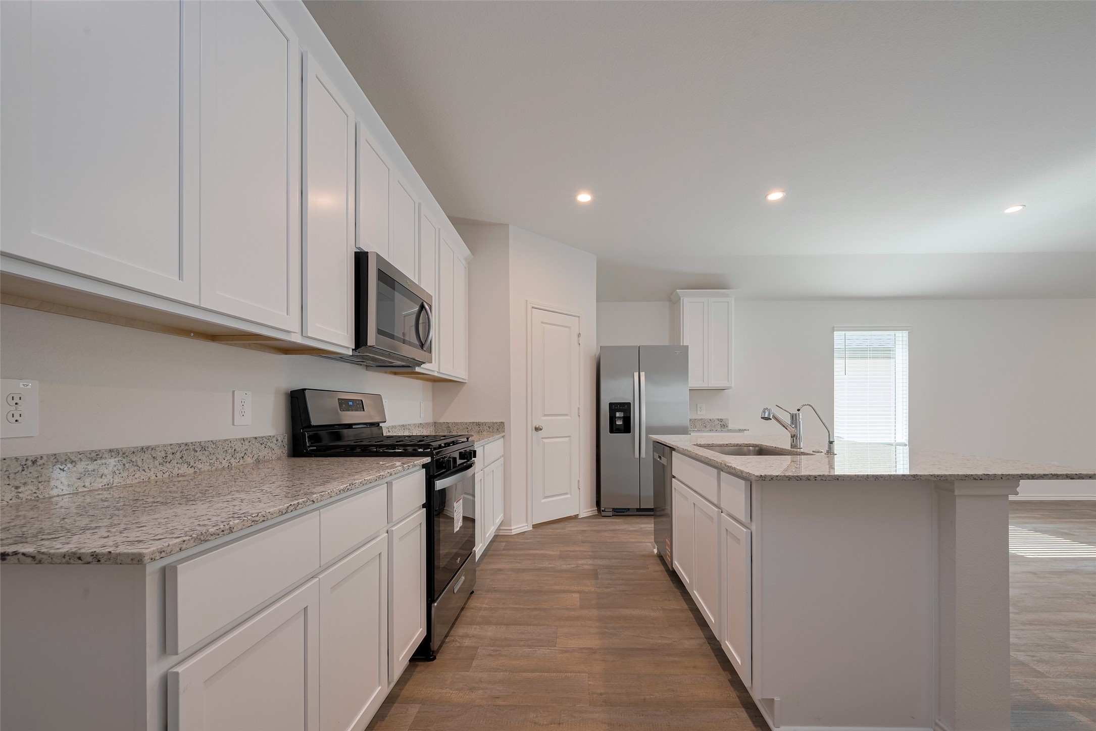 30842 Brightwell Bend Fulshear, TX 77441 - Photo 10 of 31 Bright white cabinetry lines both the upper and lower wall, paired with generous counter space to accommodate cooking essentials and showcase a clean, timeless design.