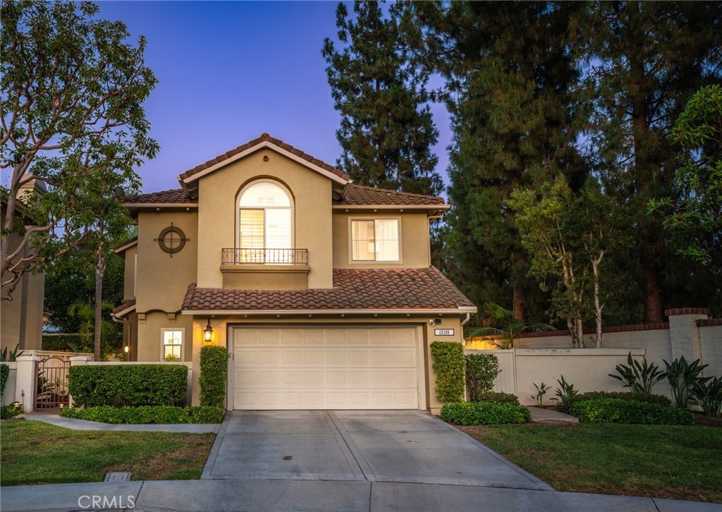 12160 Lamb Drive Tustin, CA 92782 - Photo 1 of 1 a front view of a house with a yard and garage